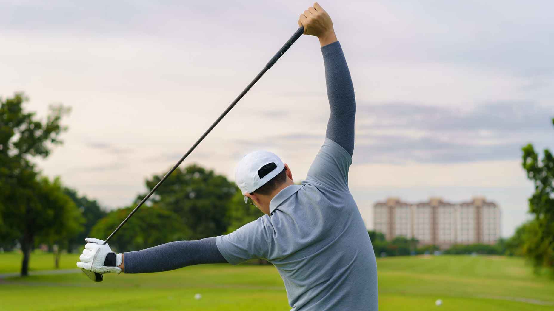 golfer stretching on the driving range