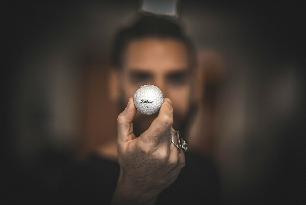 Golfer looking at a golf ball